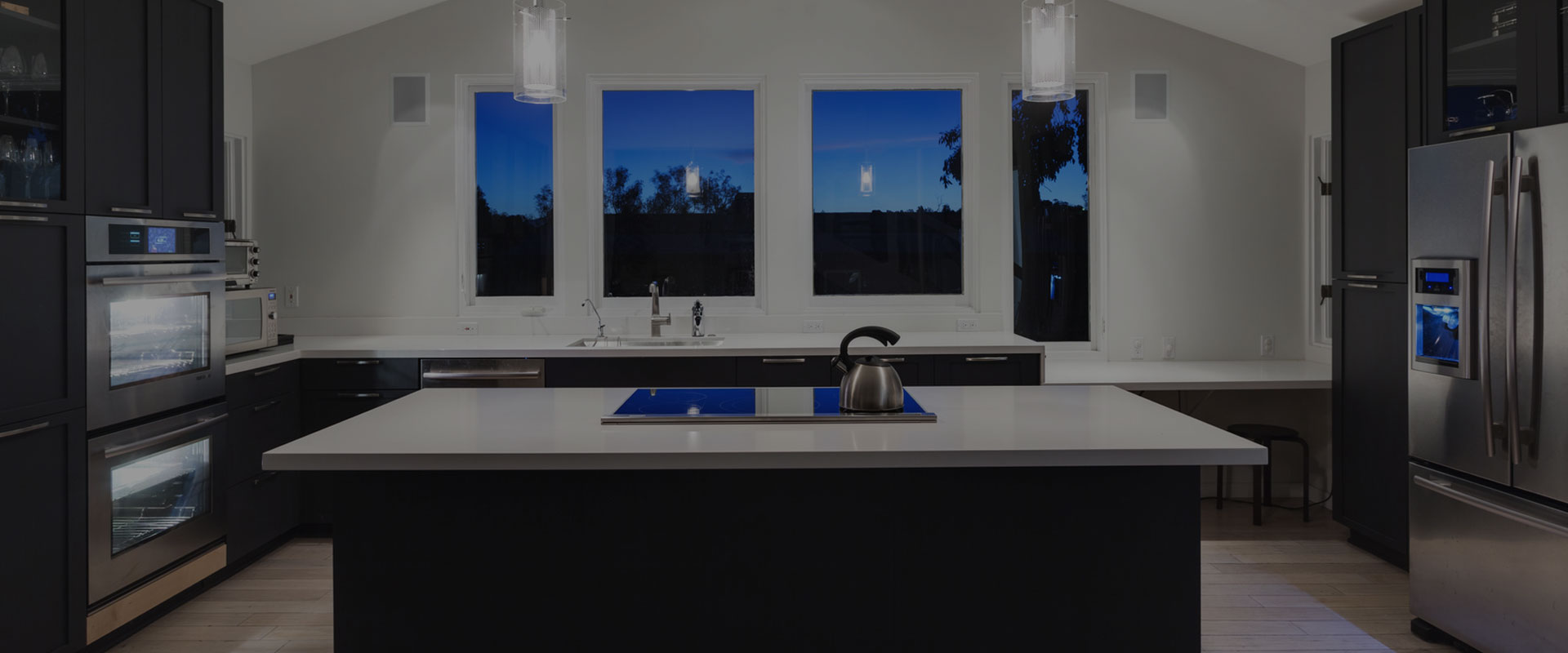 quartz worktops in kitchen with night time view from windows